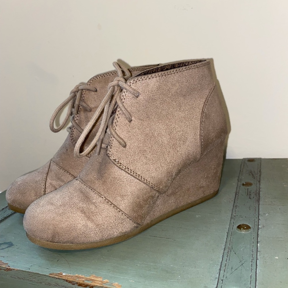 Tan suede City Classified lace up booties.